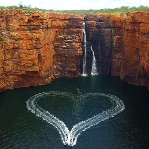 Aerial view of two tenders making a heart shape with the wake of the boats