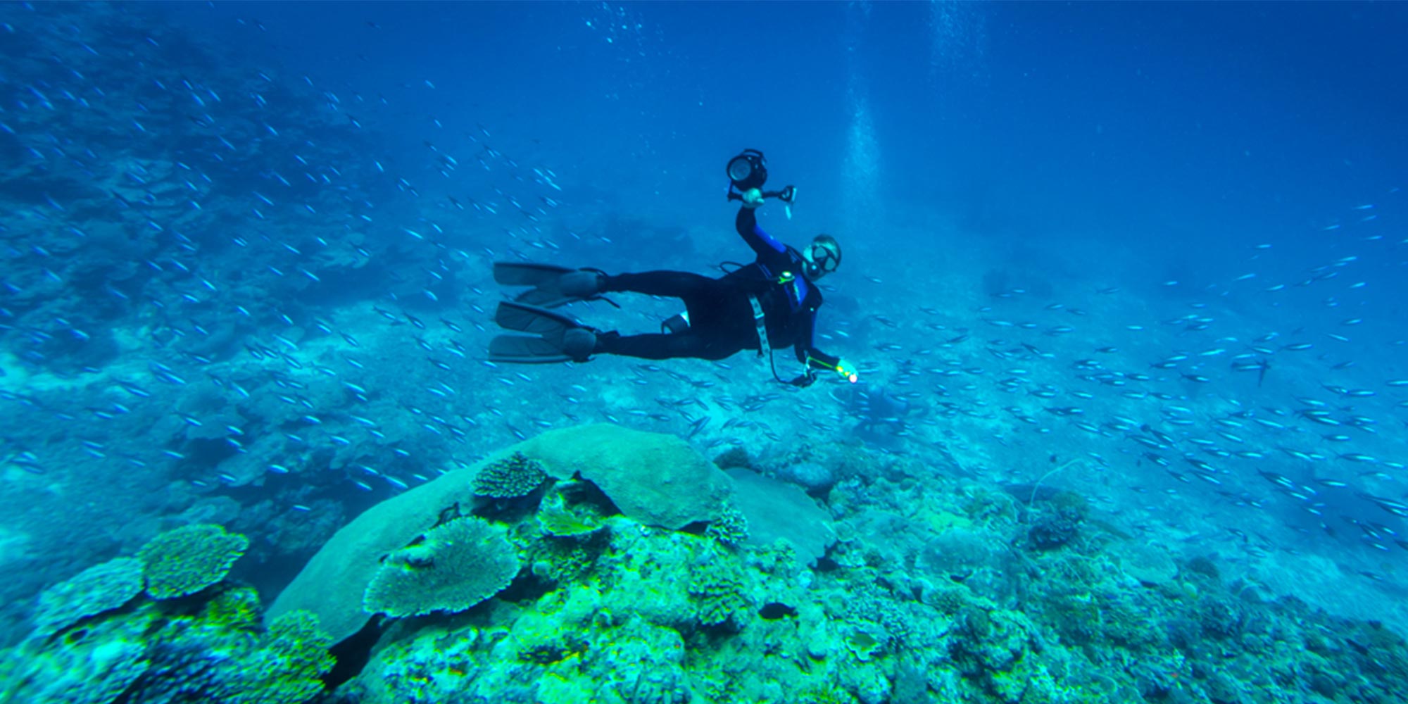 Scuba diver underwater with camera