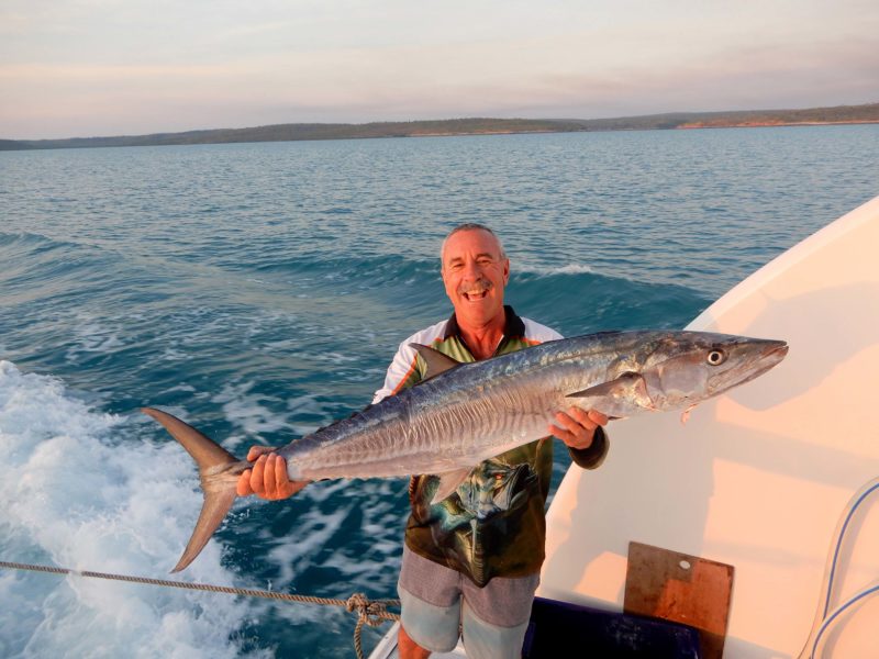 Smiling Great Escape guest holding a large fish