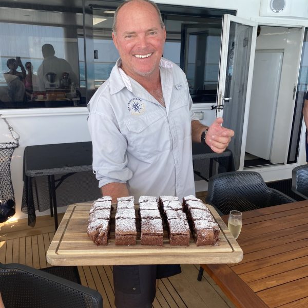 Man offering sweet treats from a platter